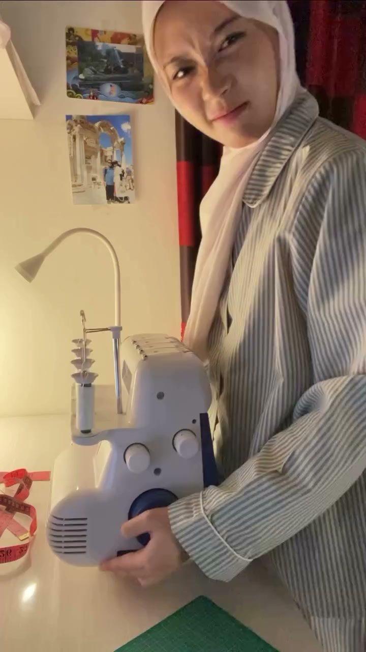 sulaem_ working at her sewing machine